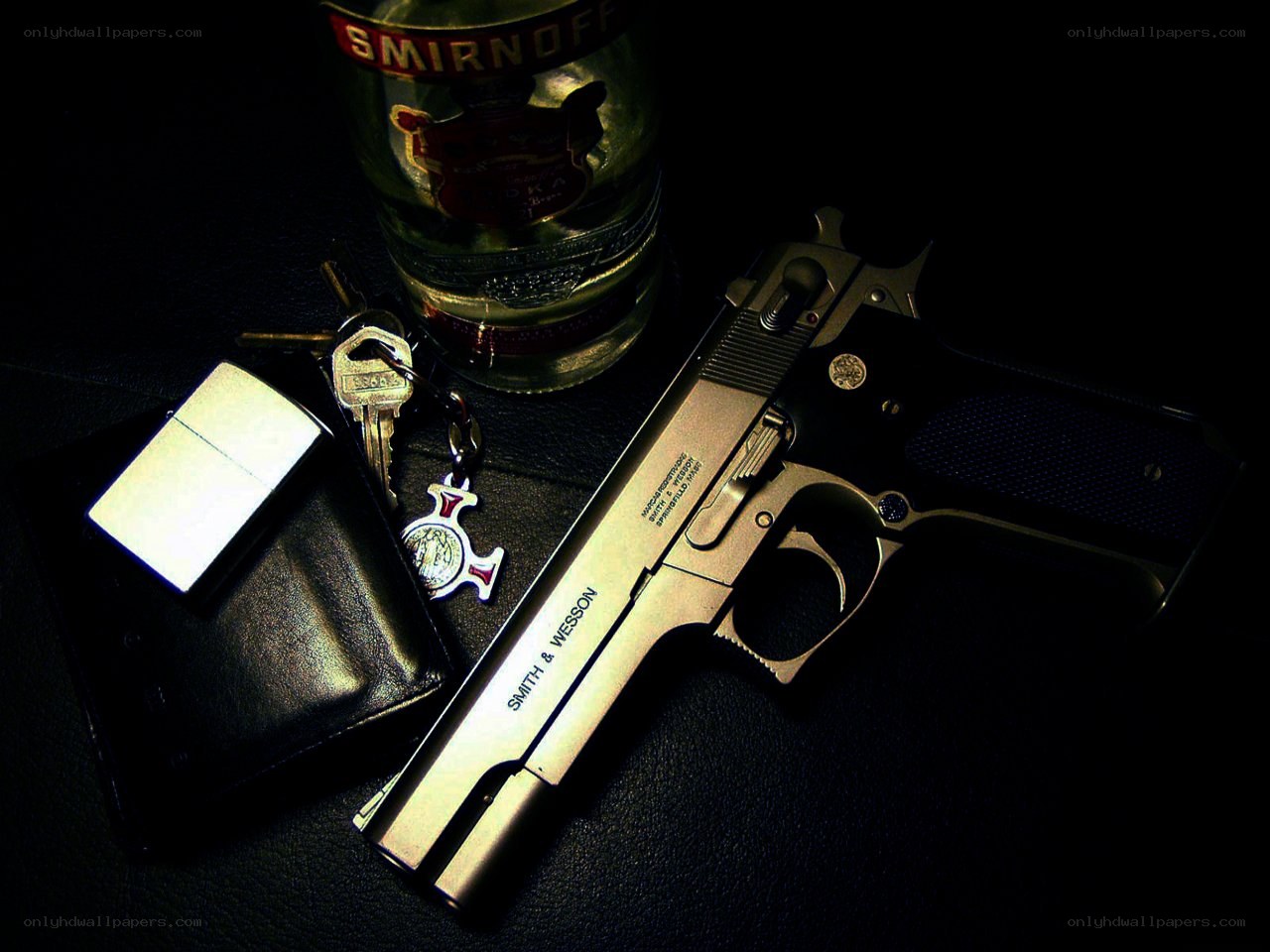 Gun and vodka on black surface