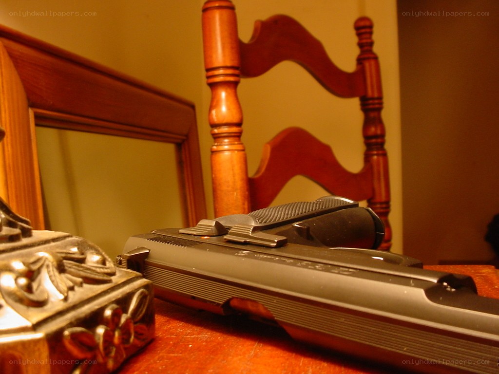 Gun on wooden table