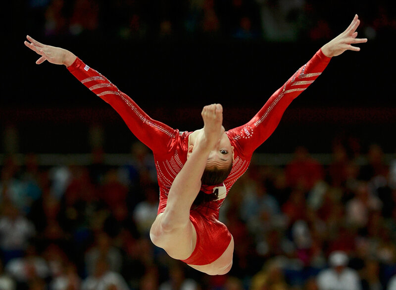 Gymnast in Red Leotard — Dynamic, Photograph, Arms Extended