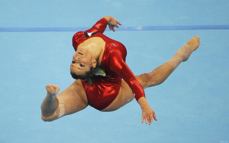 Gymnast in Red Leotard — Dynamic, Photograph