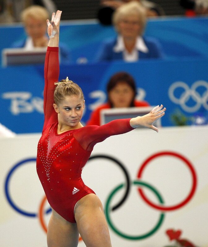 Gymnast in Red Leotard — Focused, Photograph, Olympic Rings, Judges