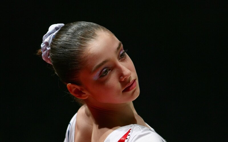gymnast in white leotard