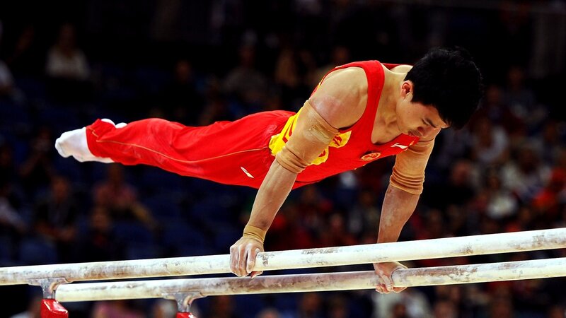 Gymnast on Parallel Bars — Red, Focused