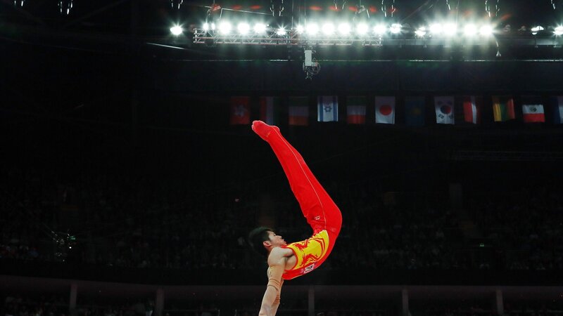 Gymnast Performing on Beam — Red