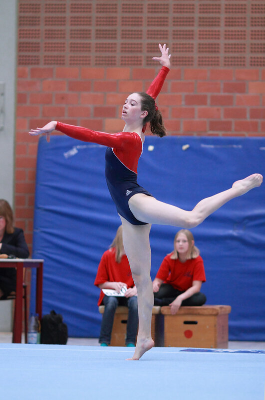 Gymnast Performing Routine — Red, Focused