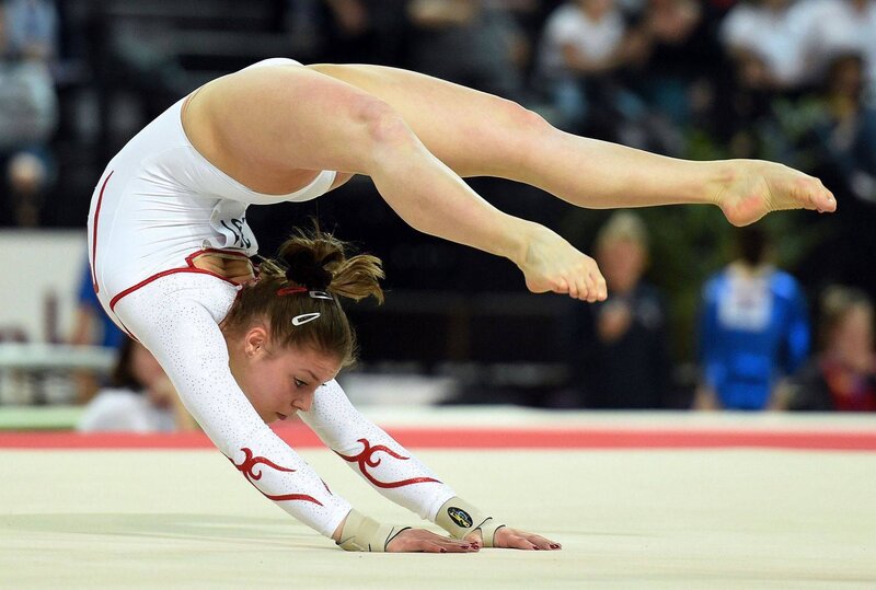 Gymnast Performing Routine — White, Focused