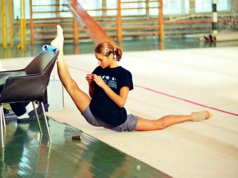 Gymnast stretching on floor