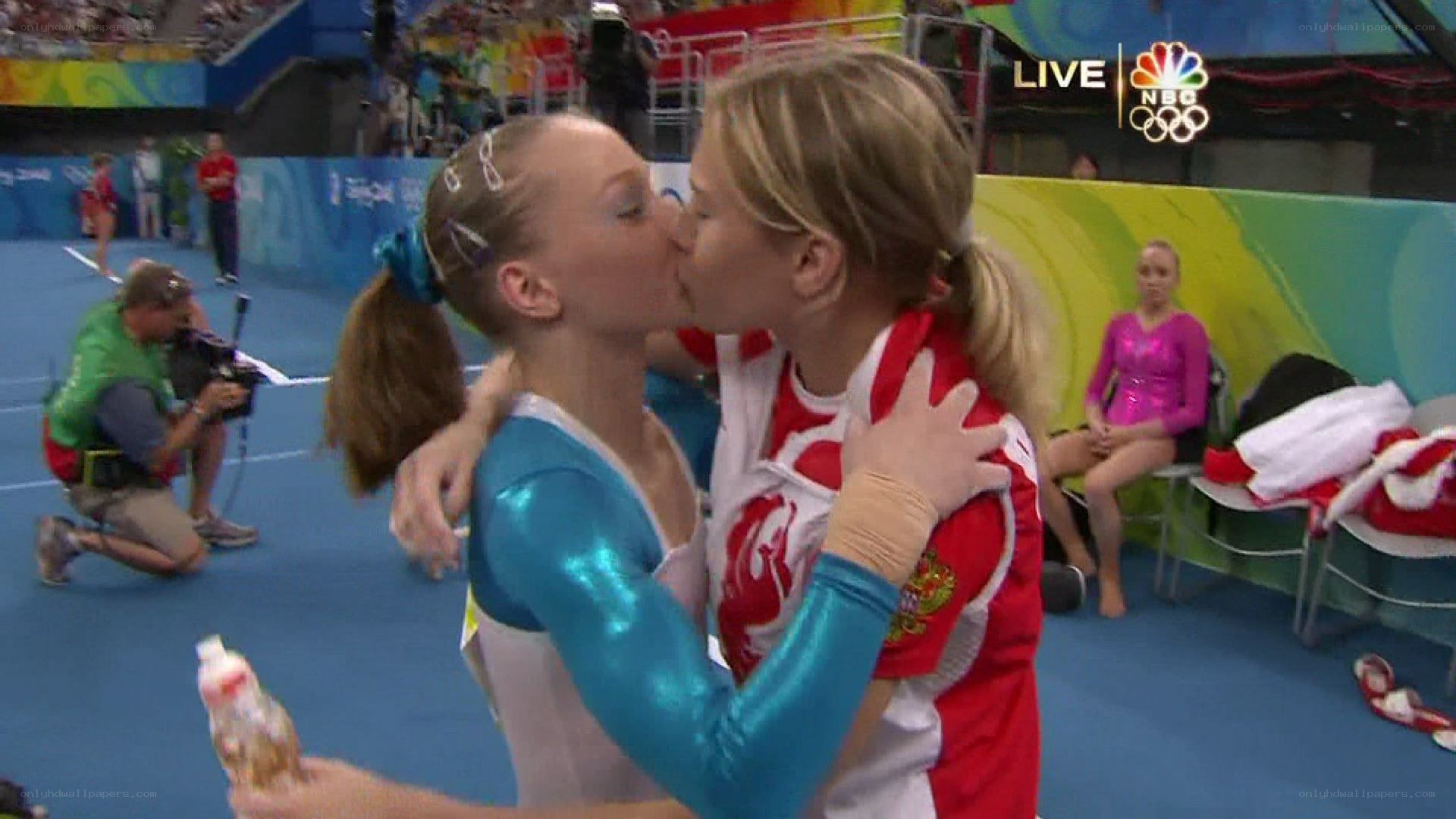 gymnasts embrace after competition