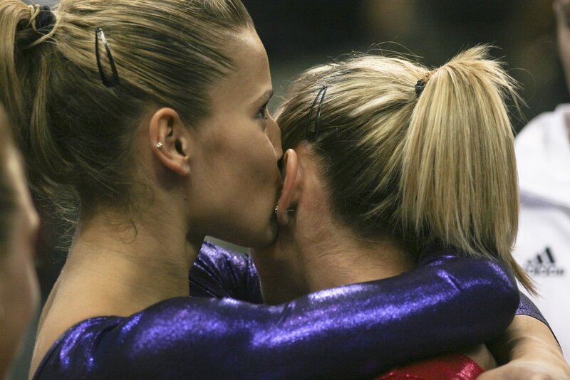 Gymnasts embracing after performance