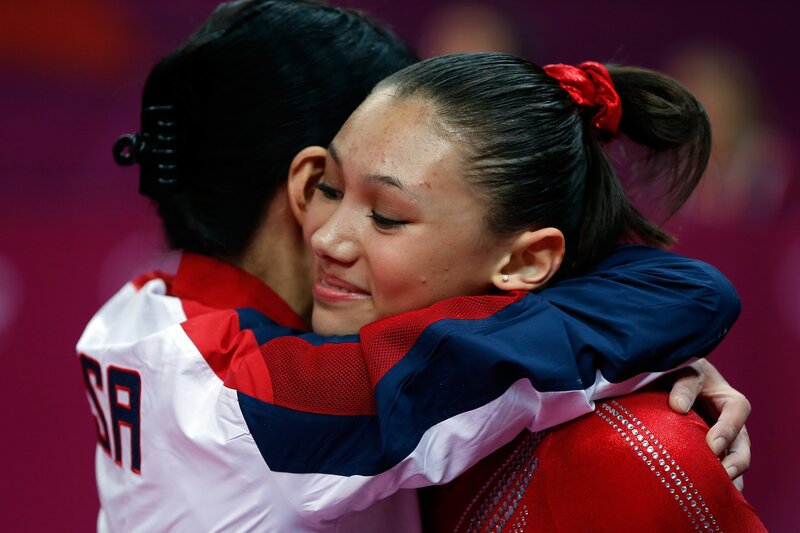 Gymnasts hugging after competition