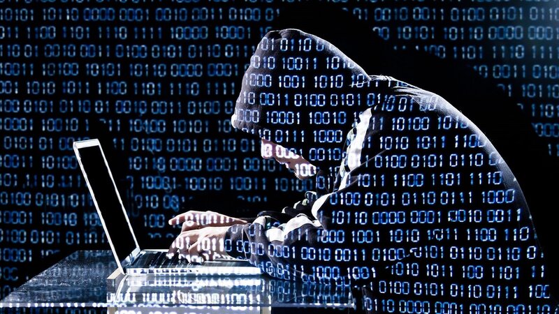 hacker using laptop at night