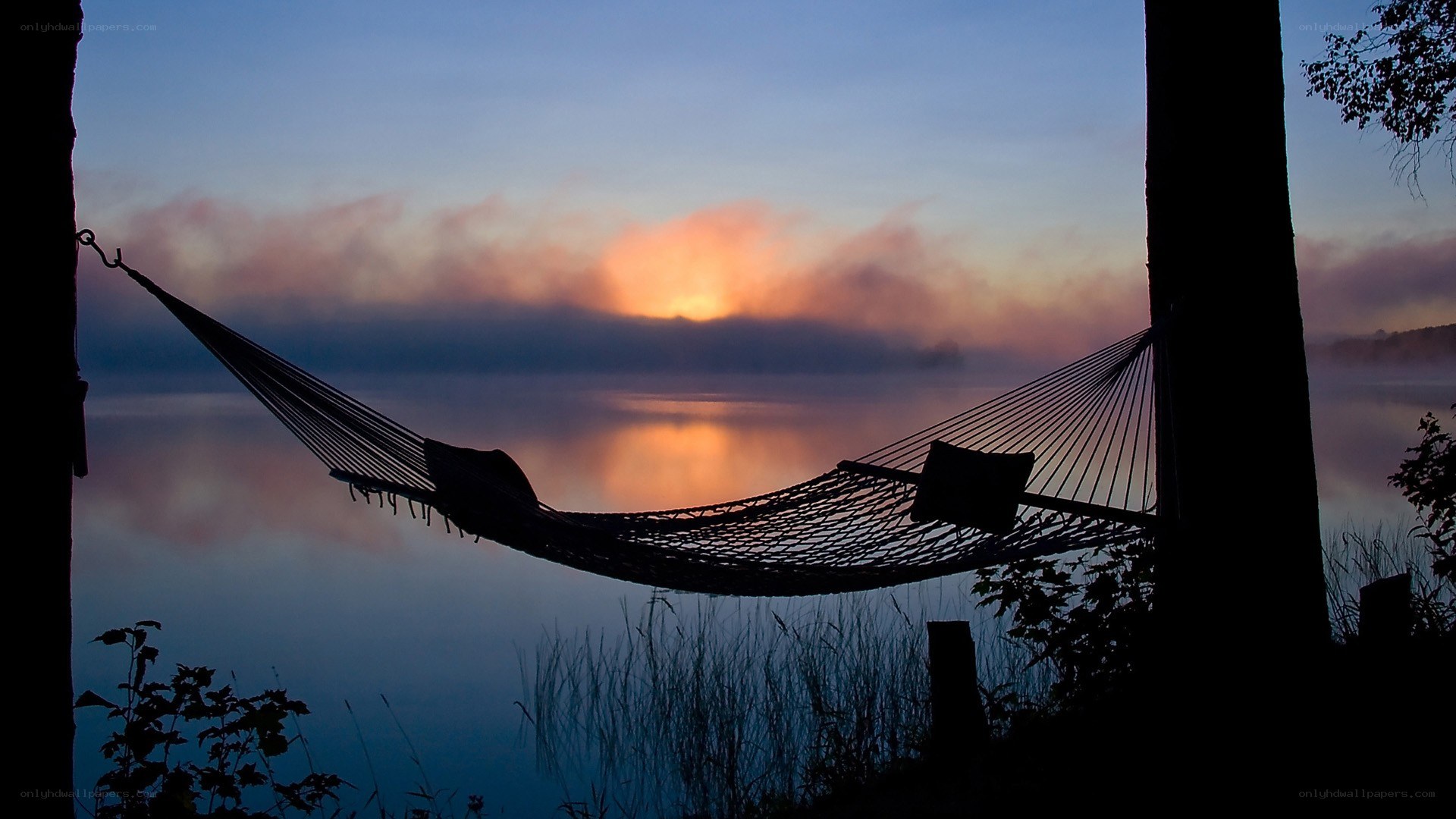 Hammock at sunrise over a lake