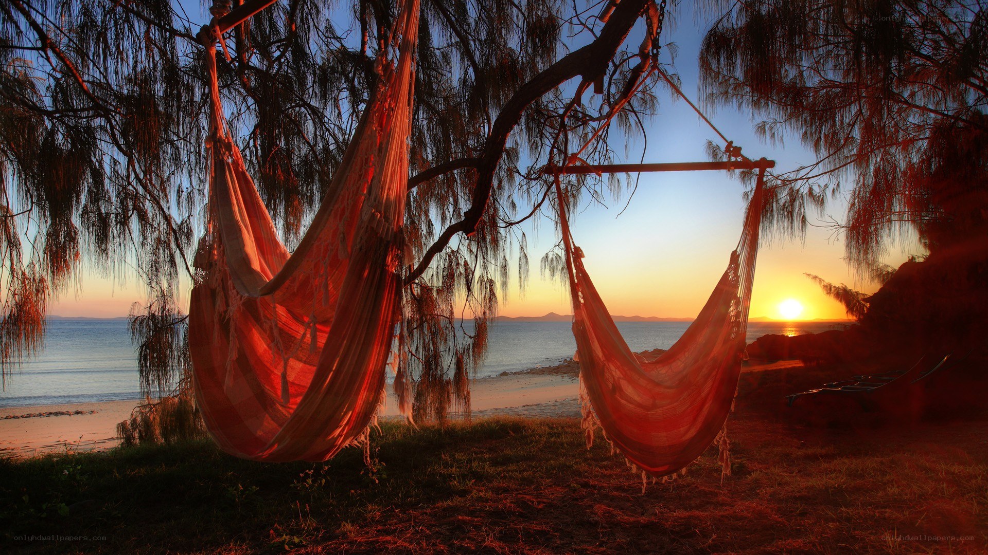 Hammocks at sunset by the sea