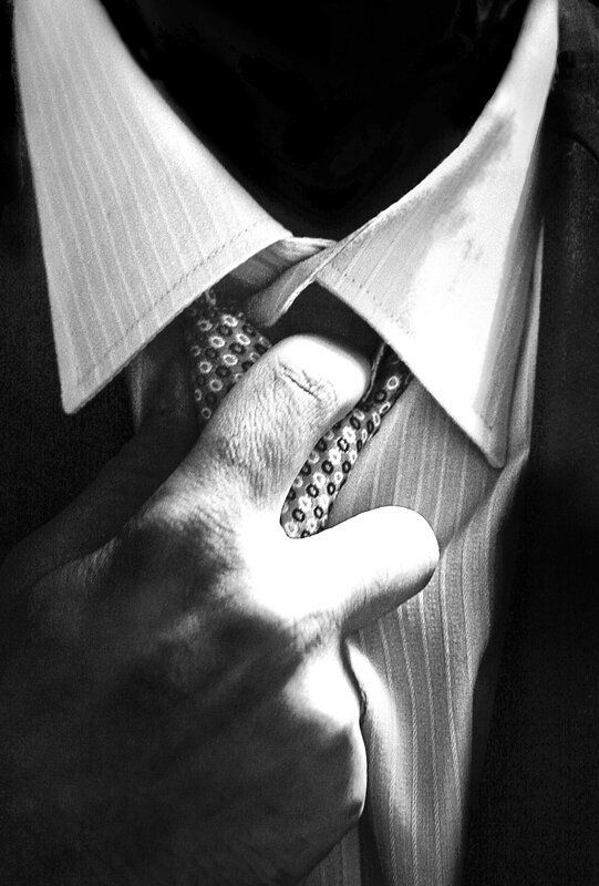 Hand Adjusting Tie — Black, Dramatic, Photograph