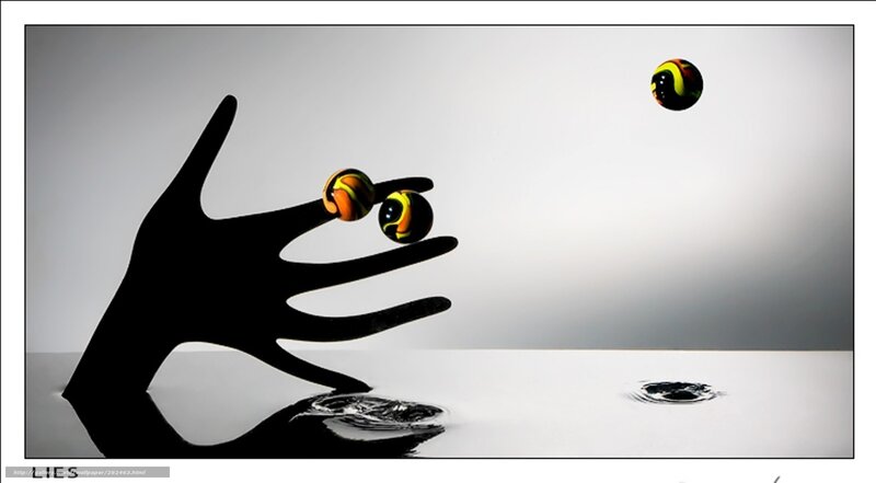 Hand and marbles in motion