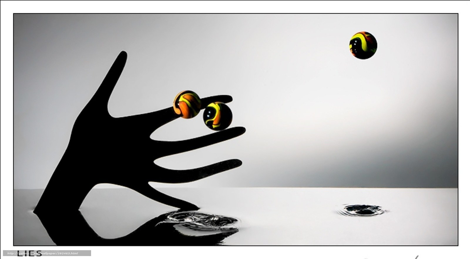 Hand and marbles in motion