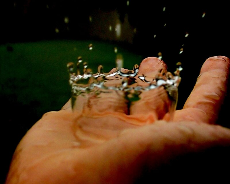 hand catching water droplets