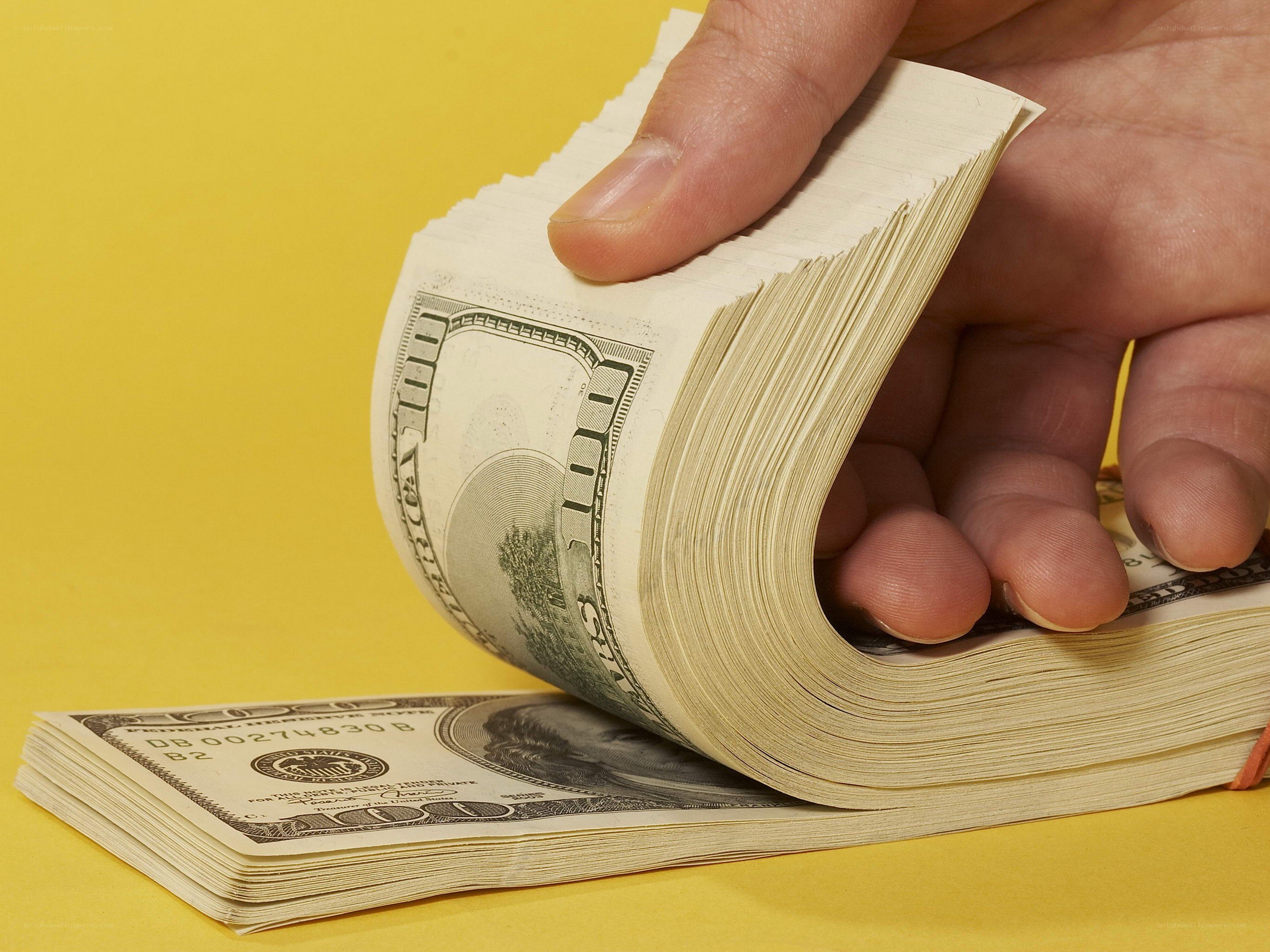 hand counting hundred dollar bills