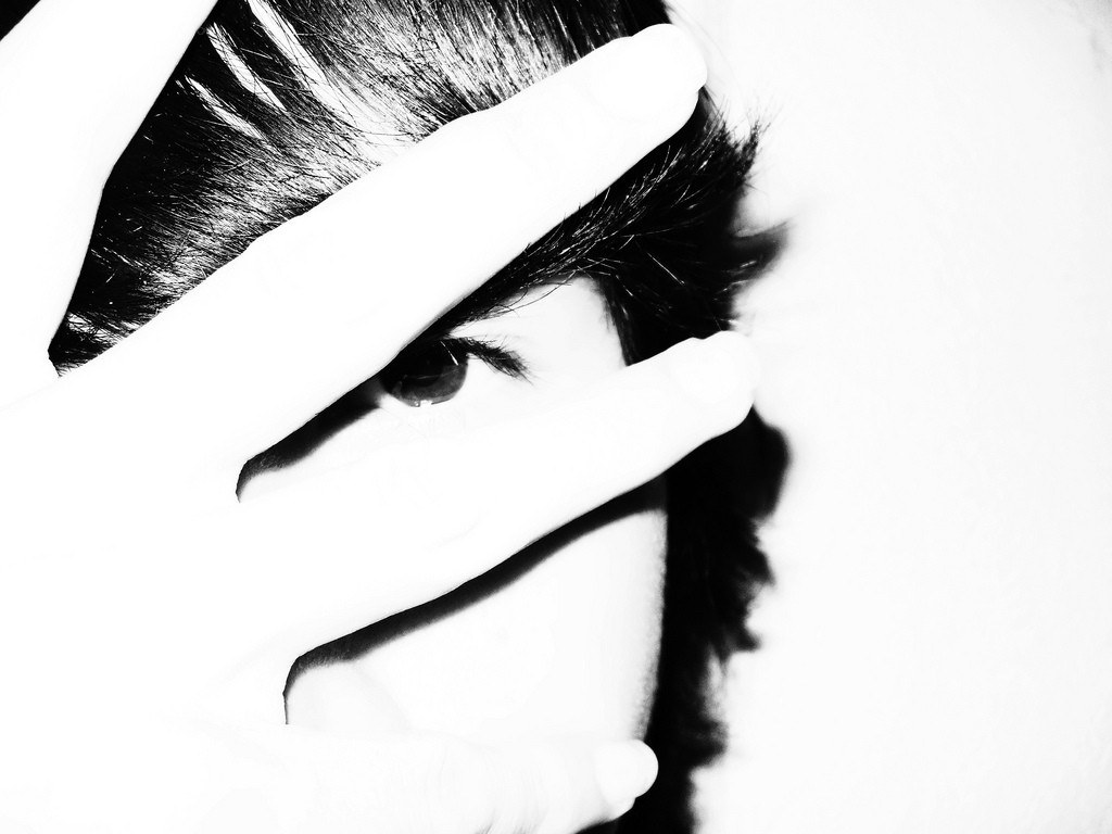 hand covering face