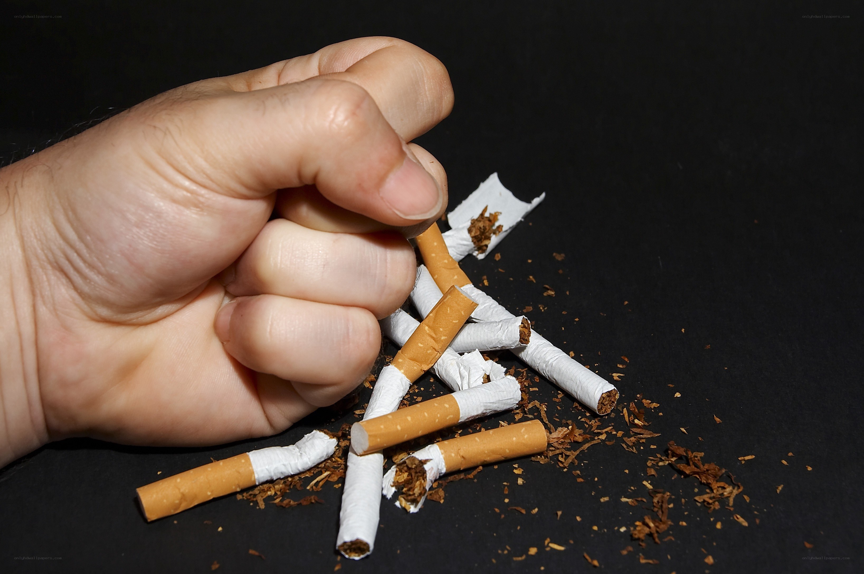 hand crushing cigarettes