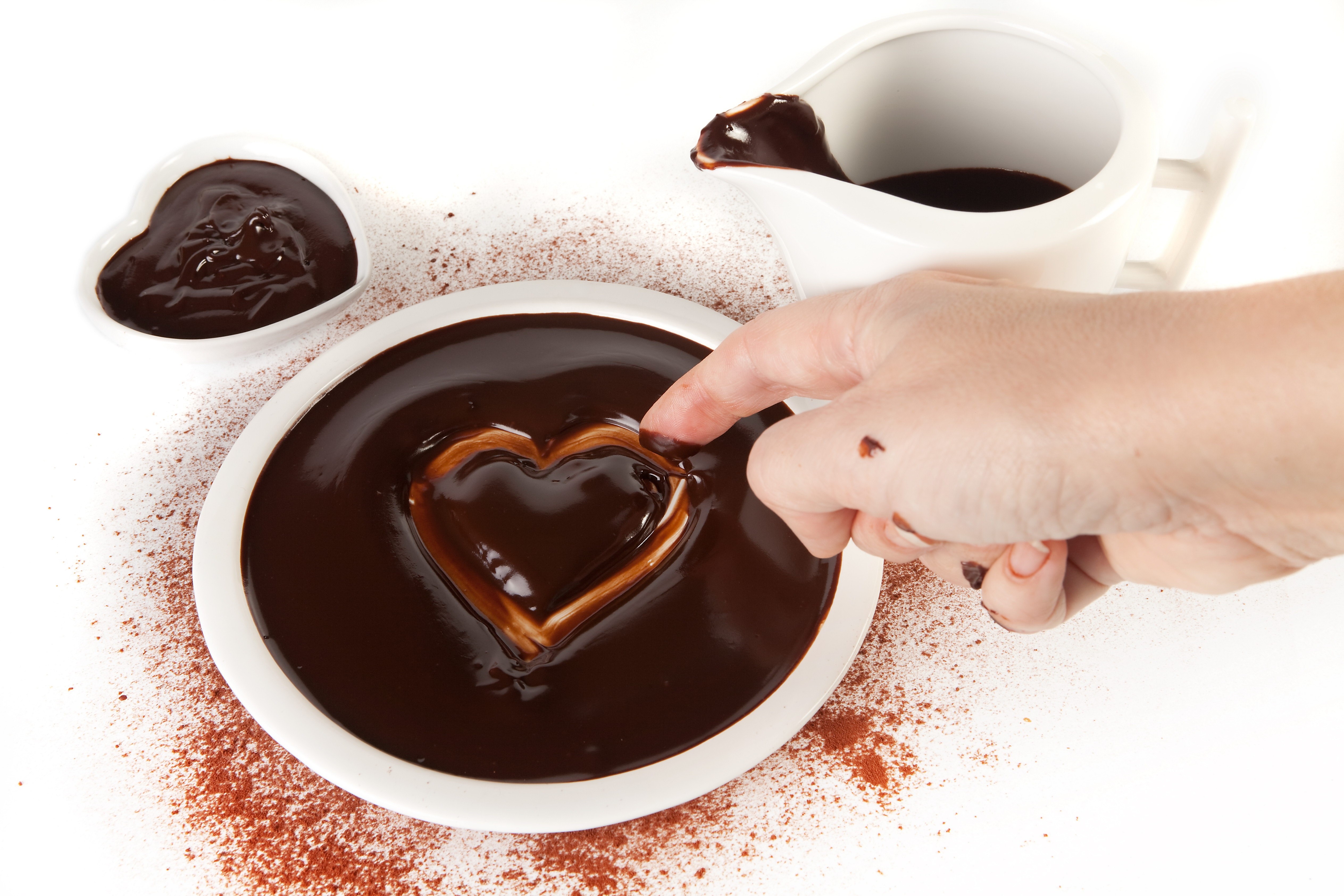 hand dipping chocolate heart