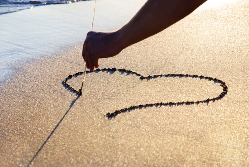 Hand Drawing Heart in Sand