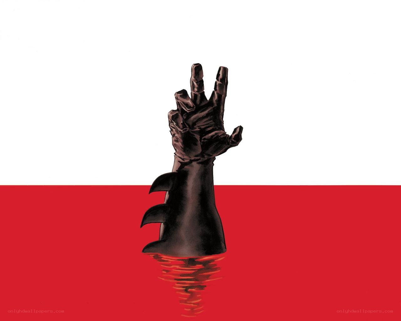 hand emerging from red liquid