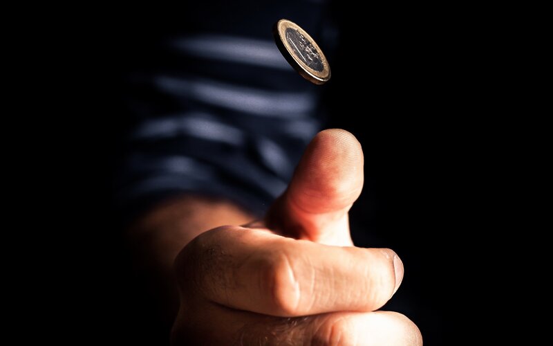Hand Flipping Coin — Black, Dramatic