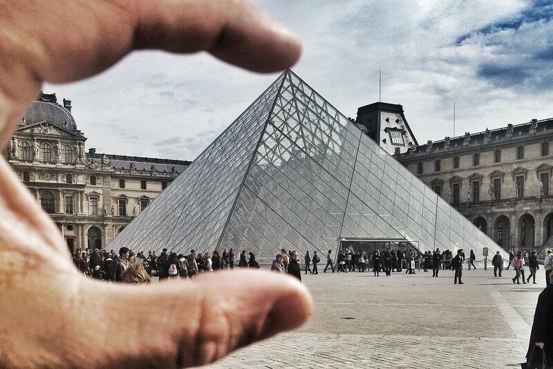 Hand framing Louvre pyramid
