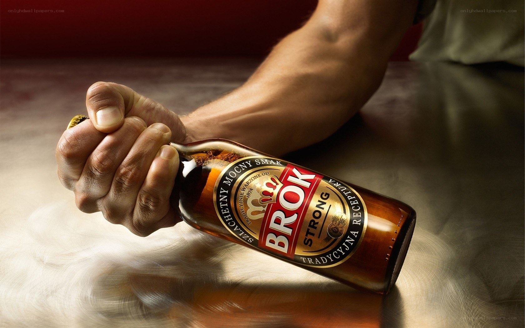 Hand holding a beer bottle