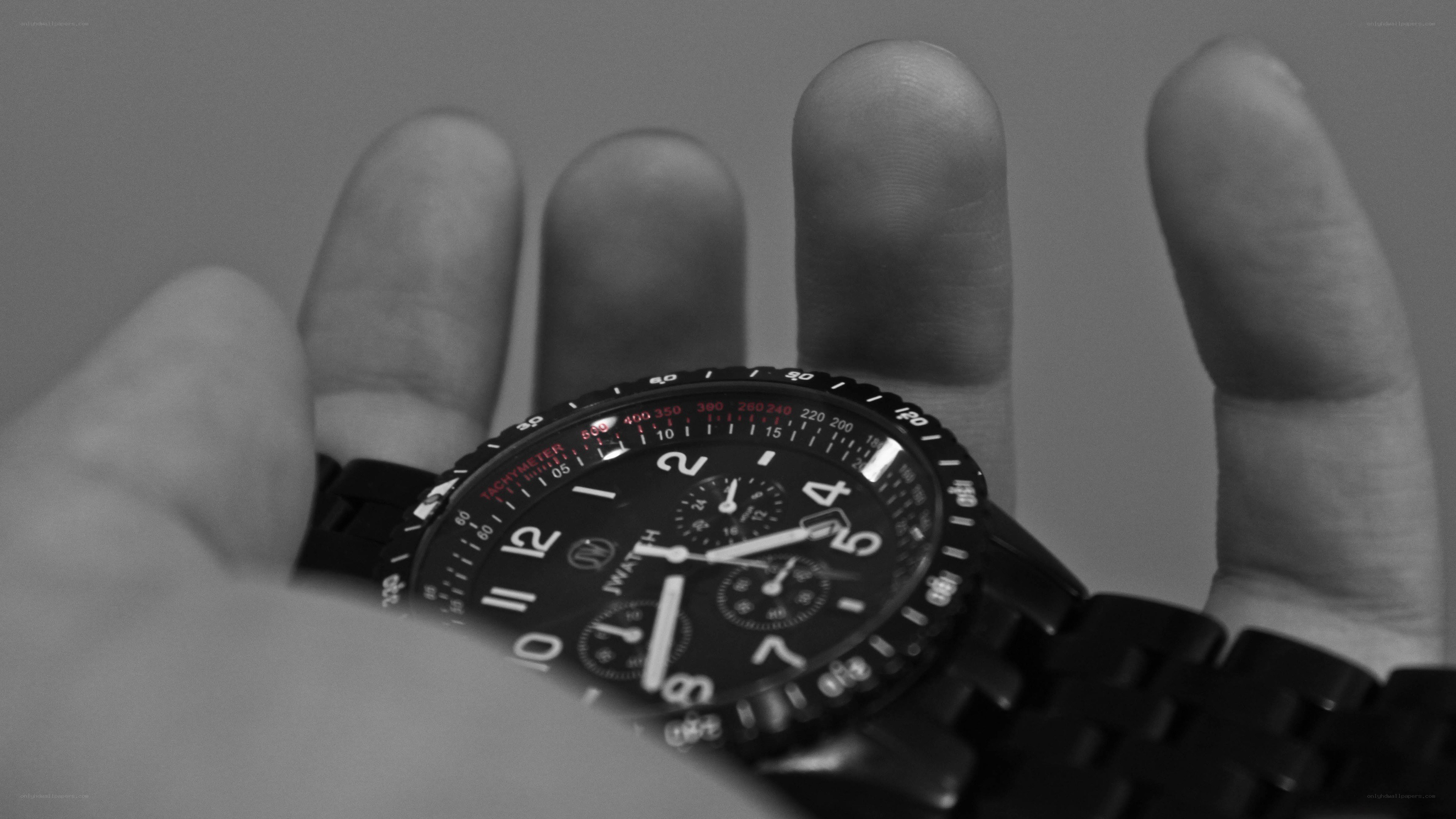 hand holding a black watch