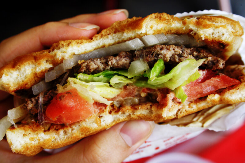 hand holding a burger