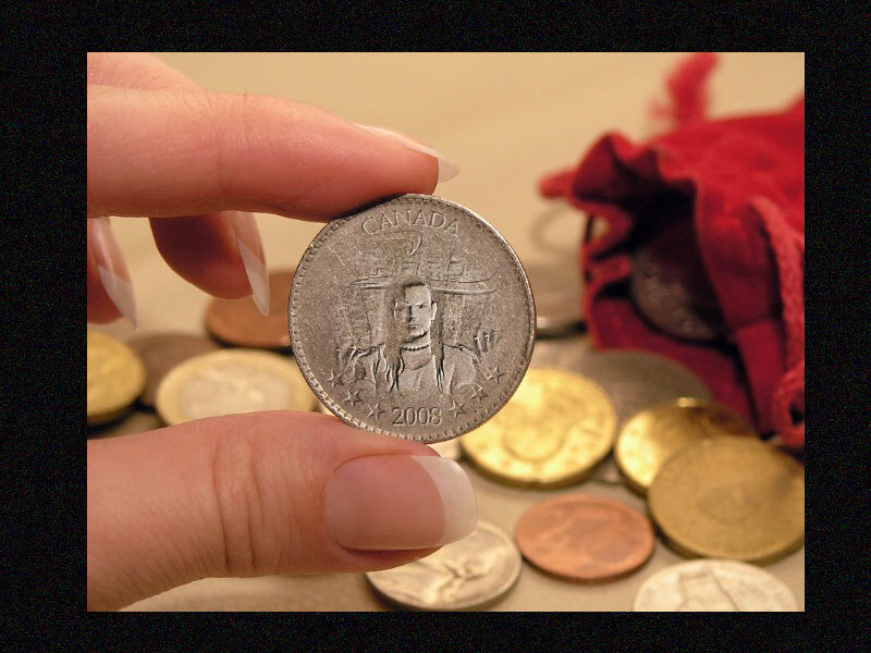 hand holding a Canadian coin