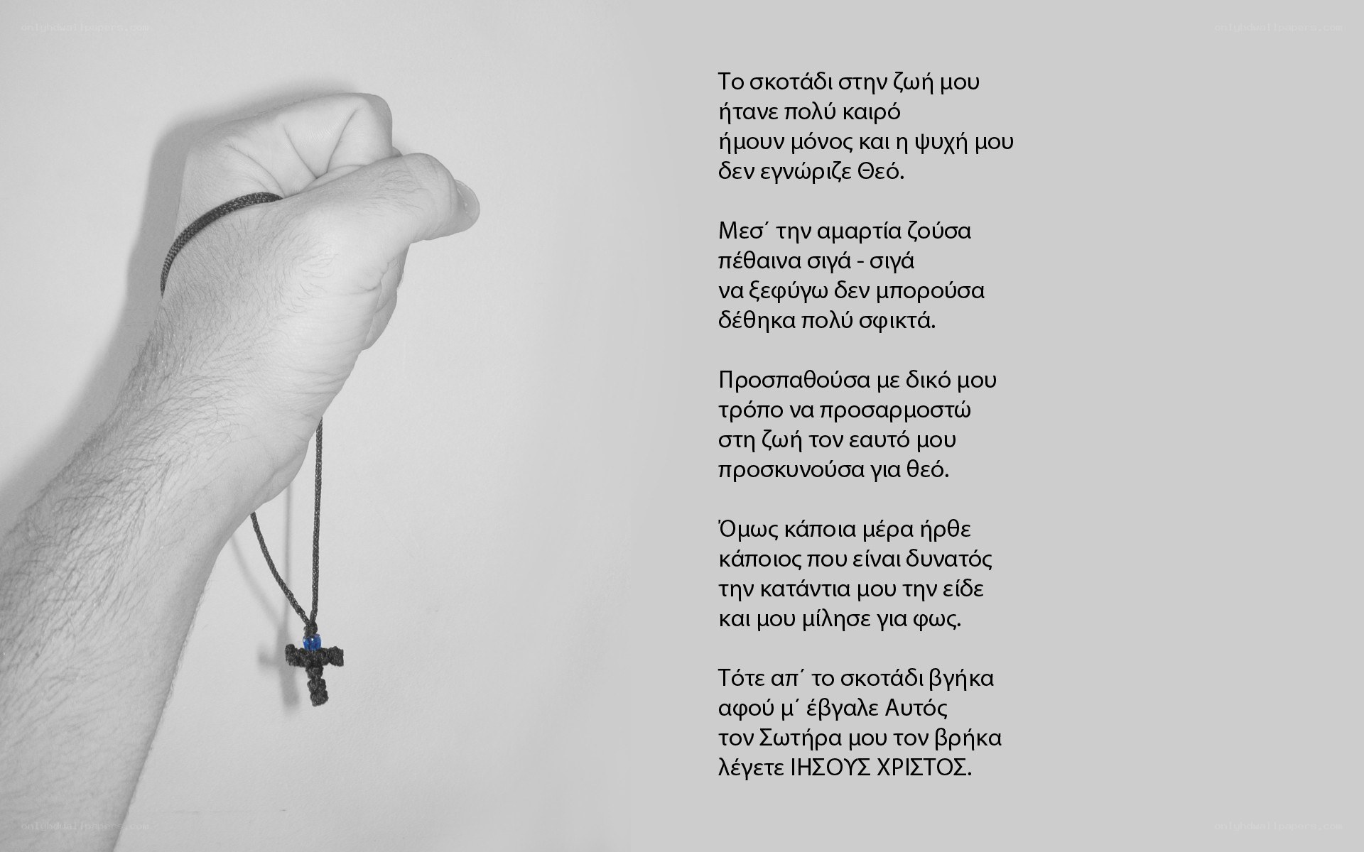 Hand holding a cross pendant