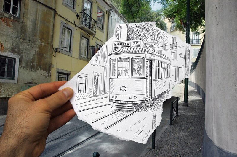 hand holding a drawing of a tram