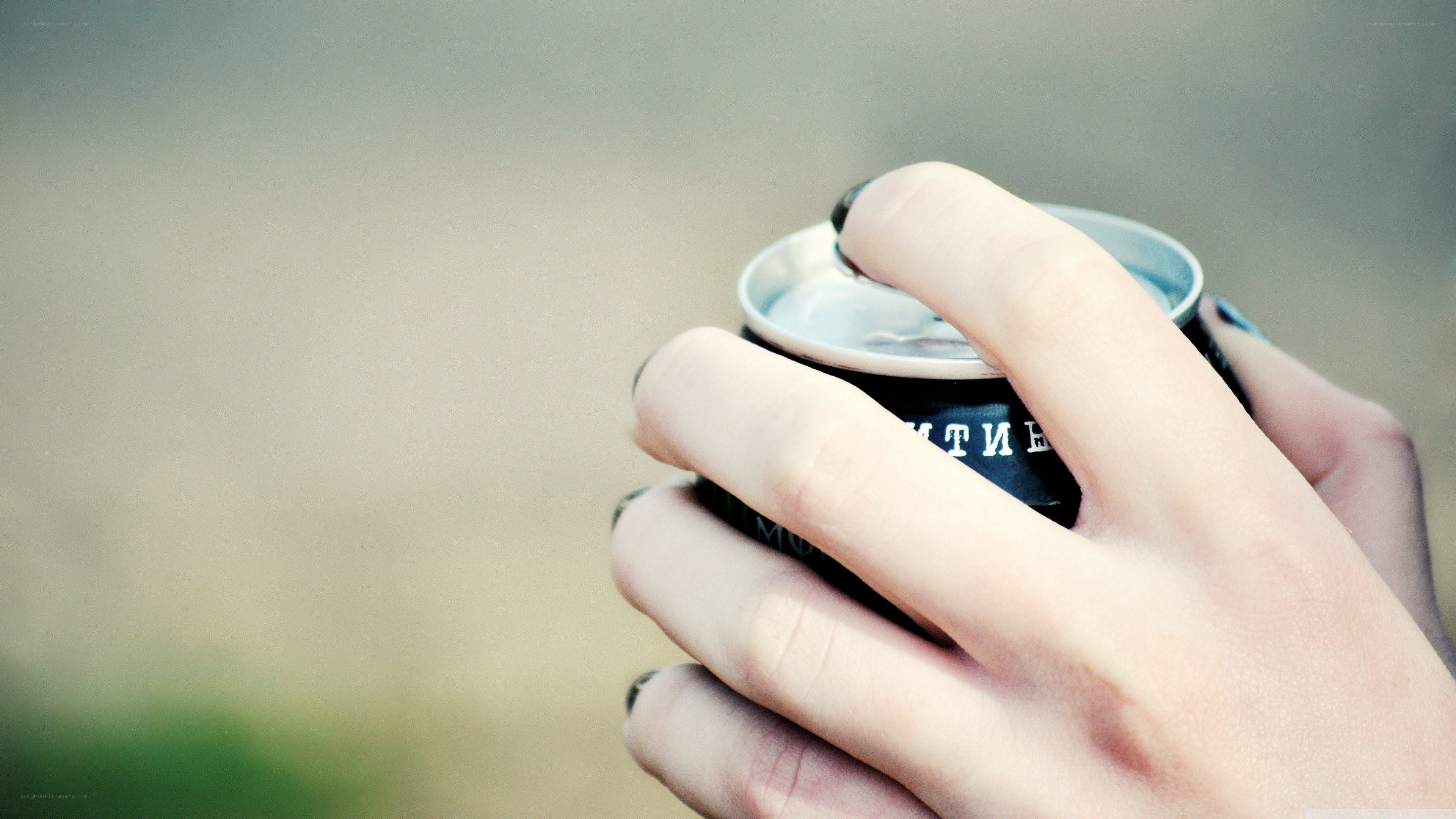 hand holding a drink can