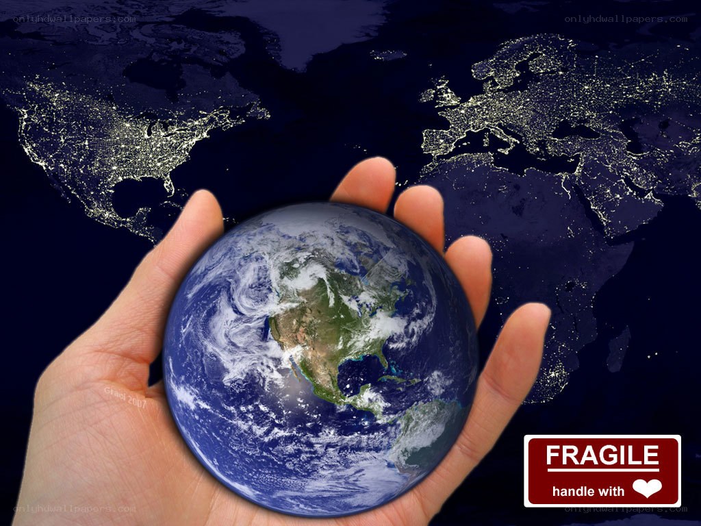 Hand holding a fragile Earth