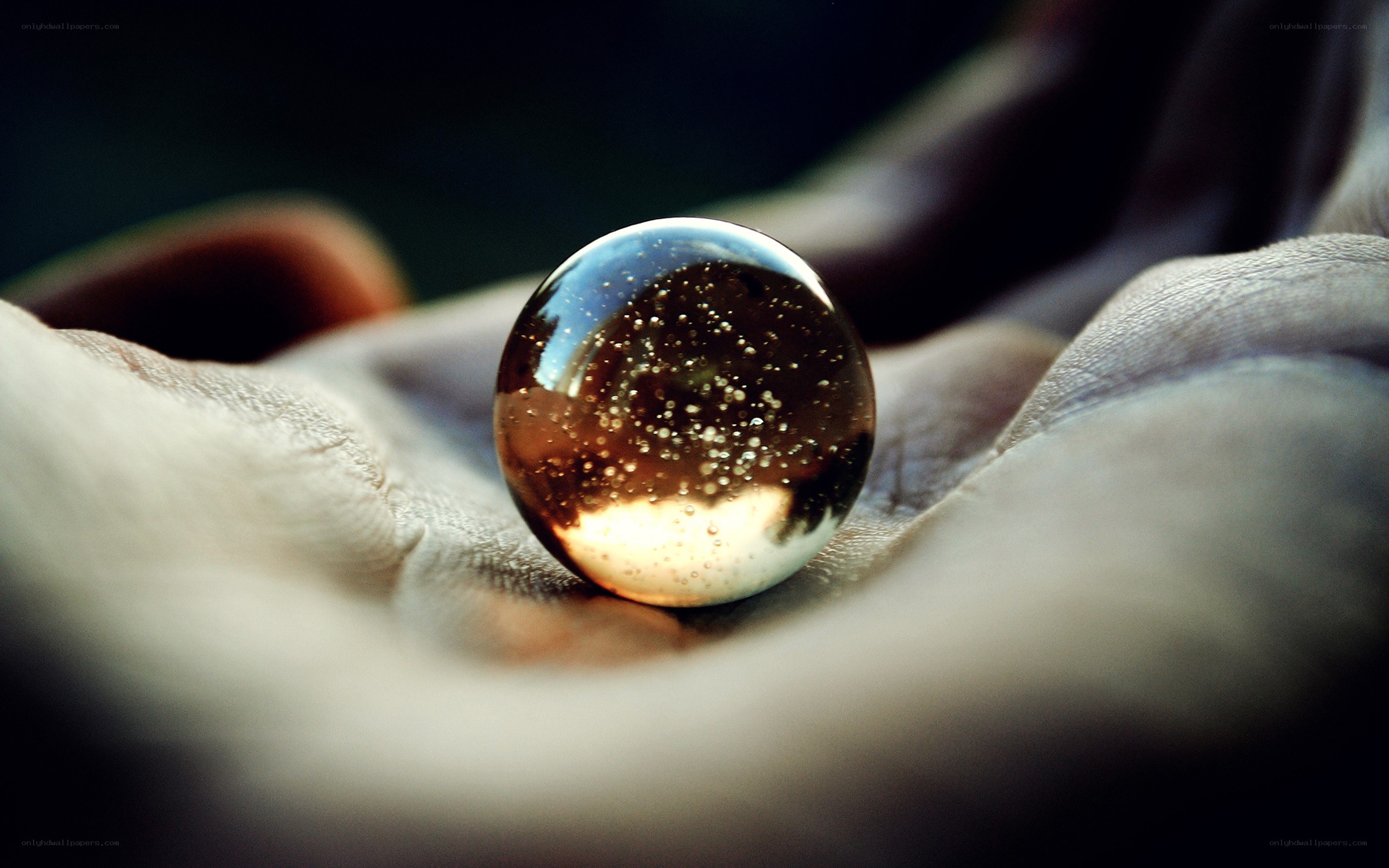 Hand holding a glass marble