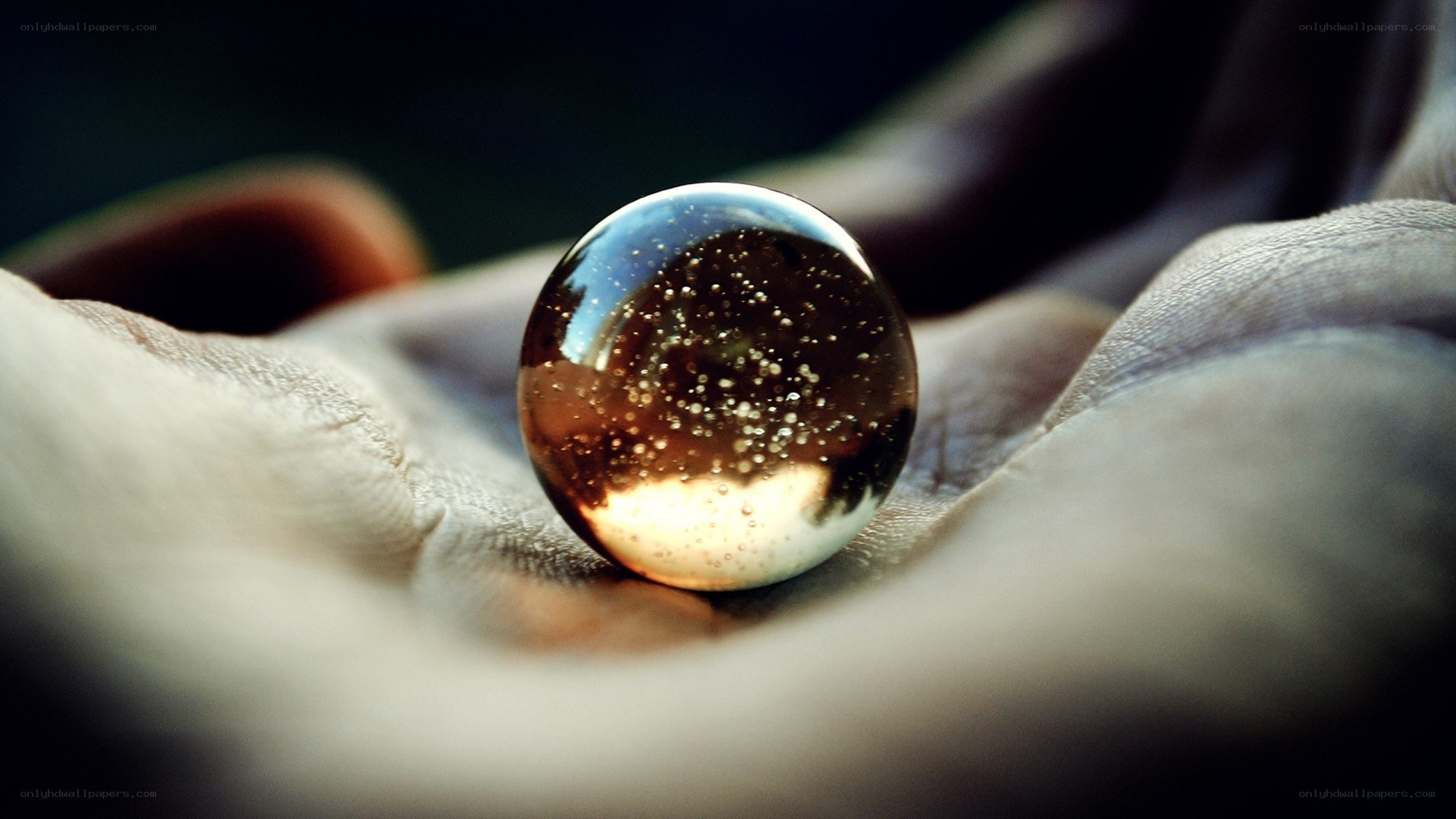 Hand holding a glass marble