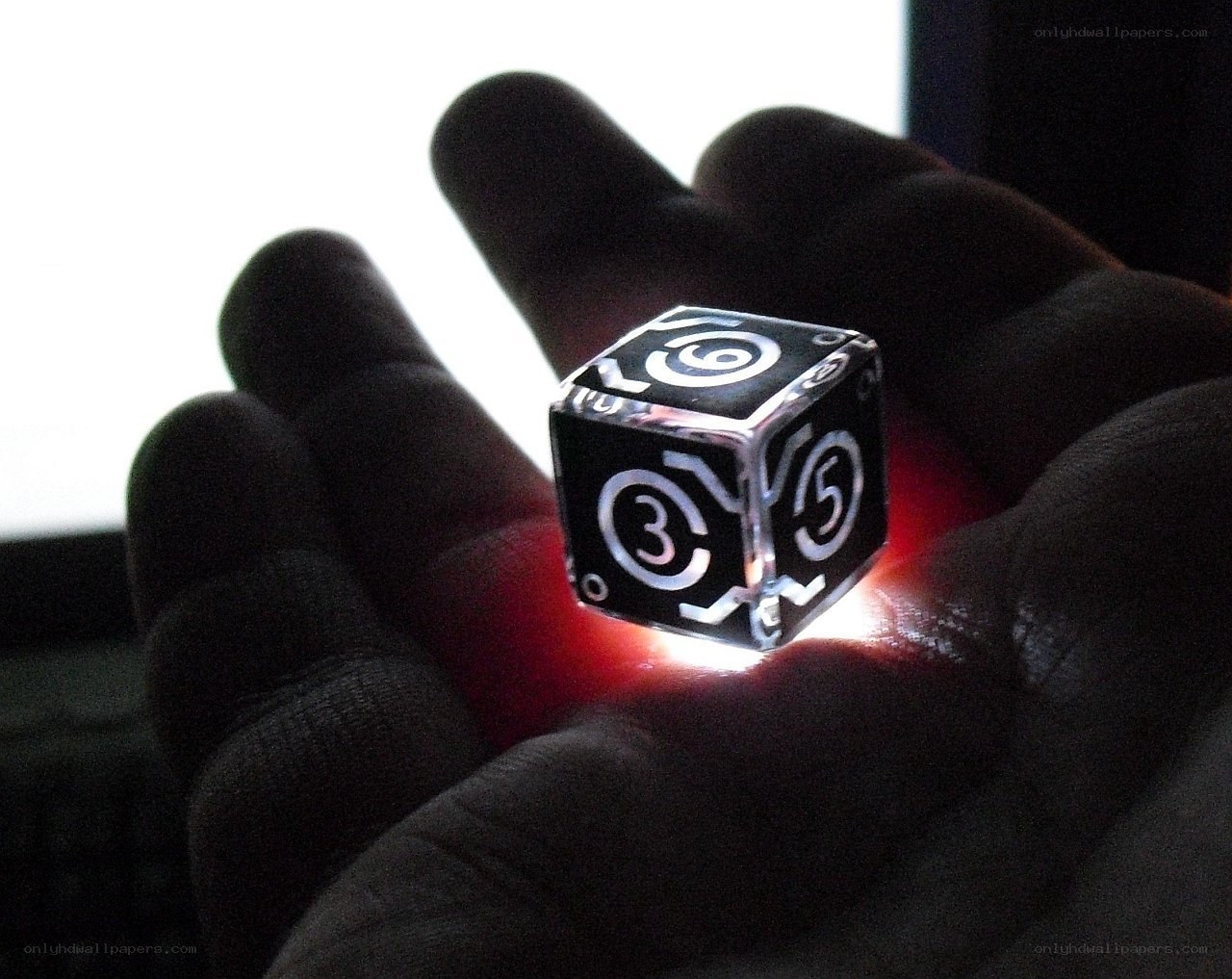 Hand holding a glowing die