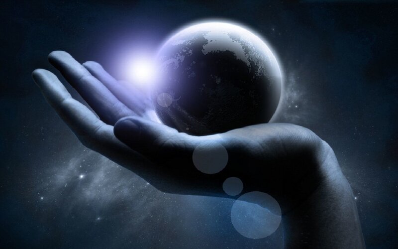 hand holding a glowing planet