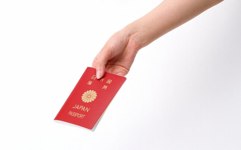 hand holding a Japanese passport