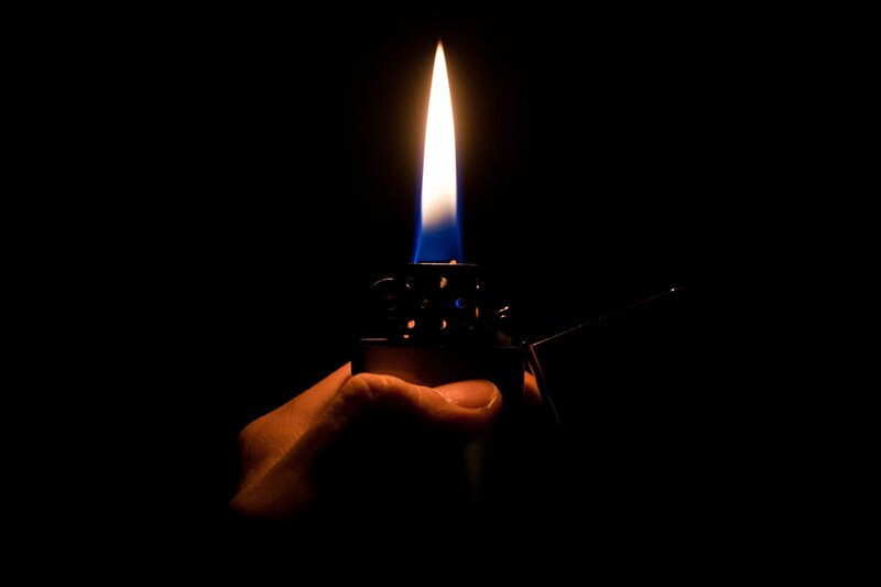 hand holding a lit lighter