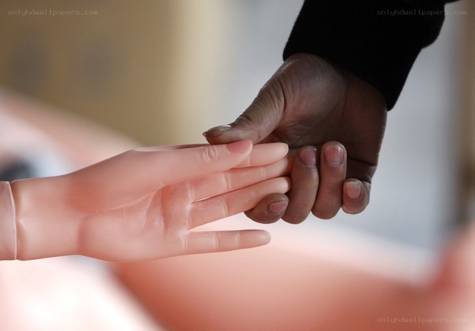 Hand holding a mannequin hand