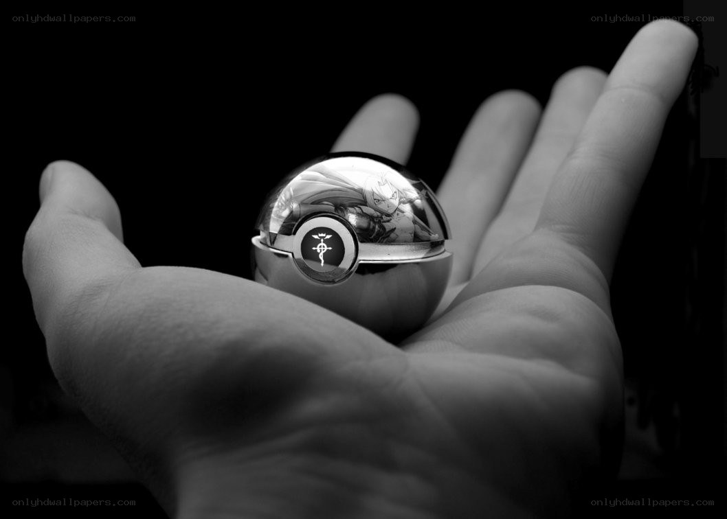 hand holding a metallic pokeball