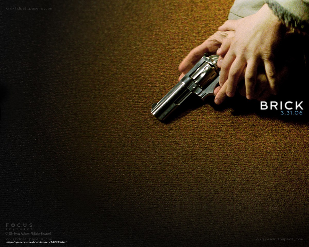 Hand holding a revolver on carpet