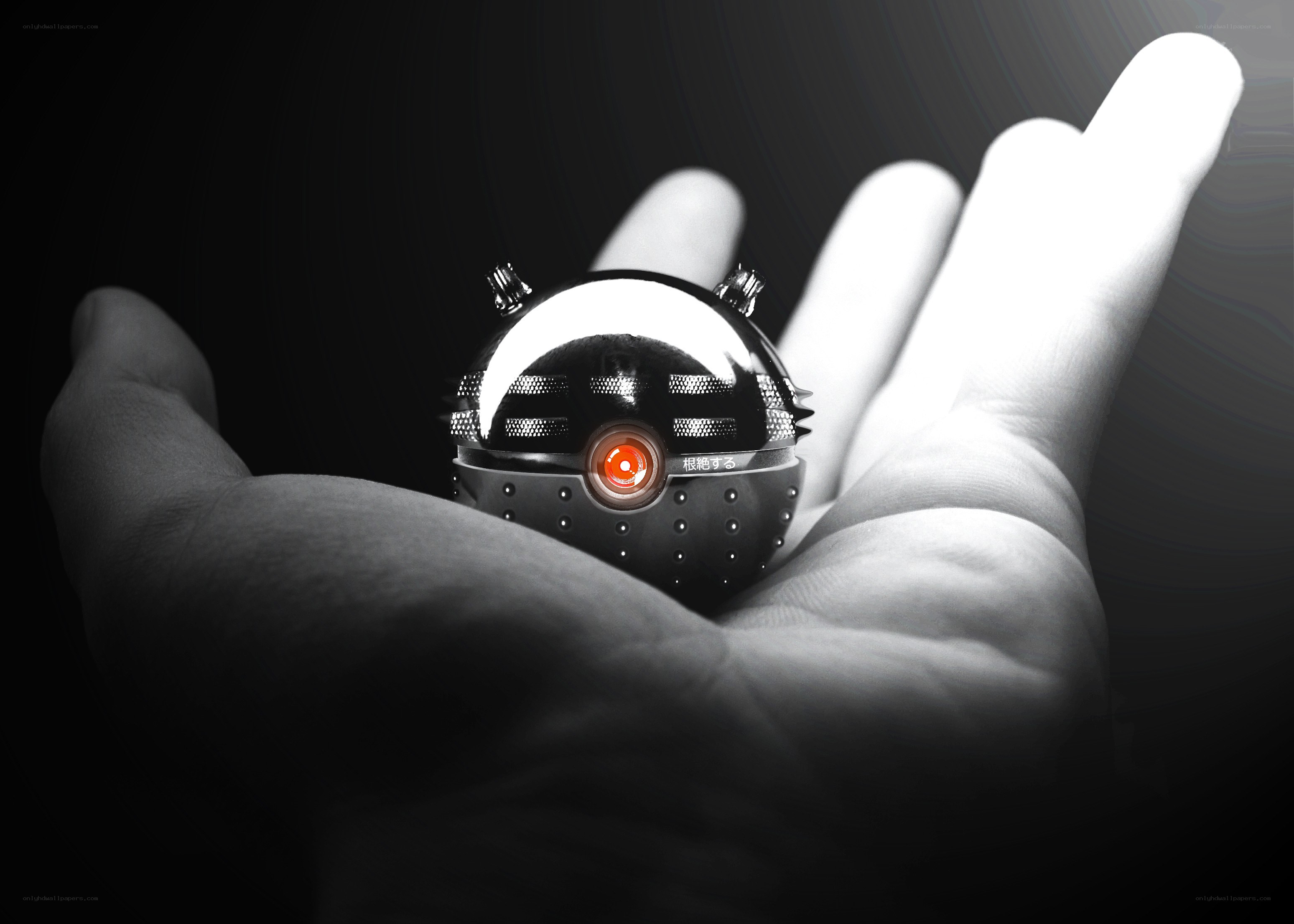 Hand holding a small robot