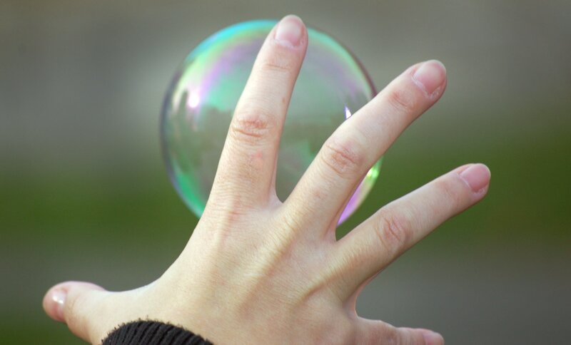 hand holding a soap bubble