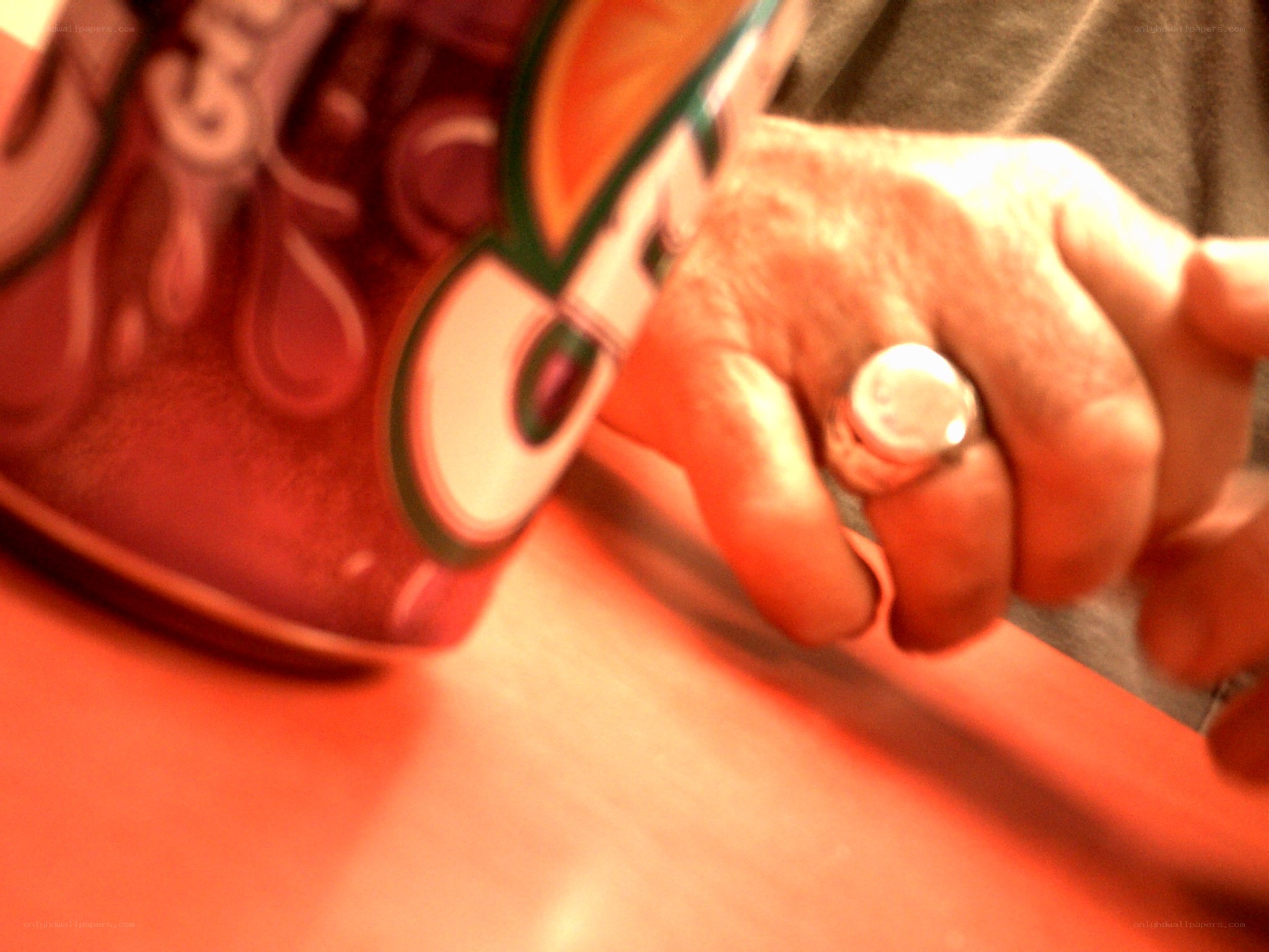 hand holding a soda can