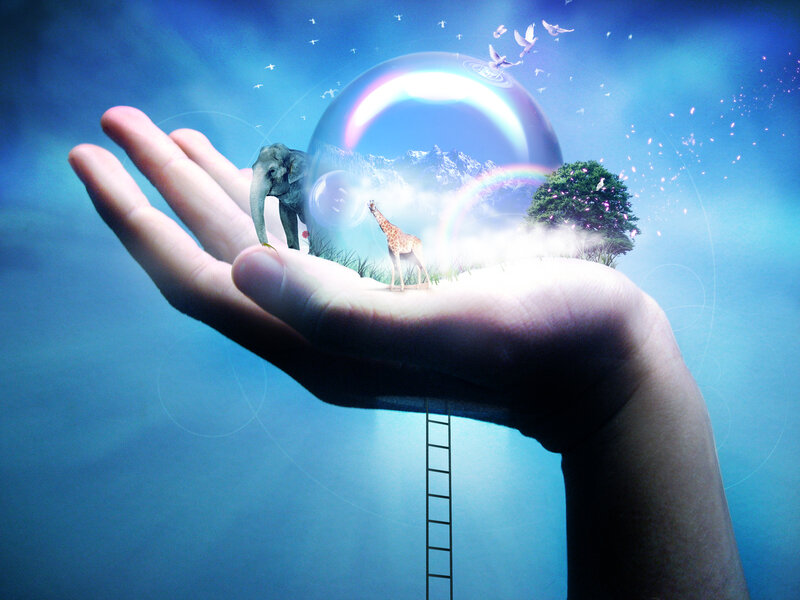 Hand holding a world in a bubble